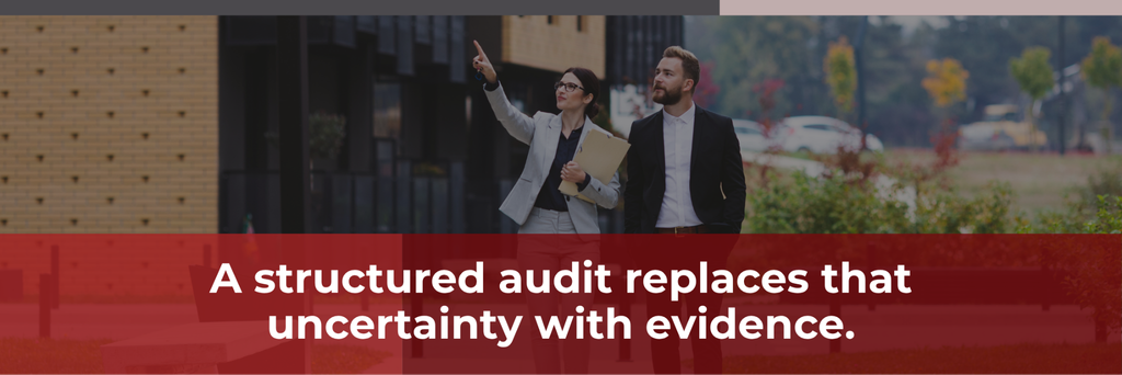 image | Manage Your Property Two business professionals in suits walking outside a building; woman points ahead while holding a folder, over a red banner with white text about audits.